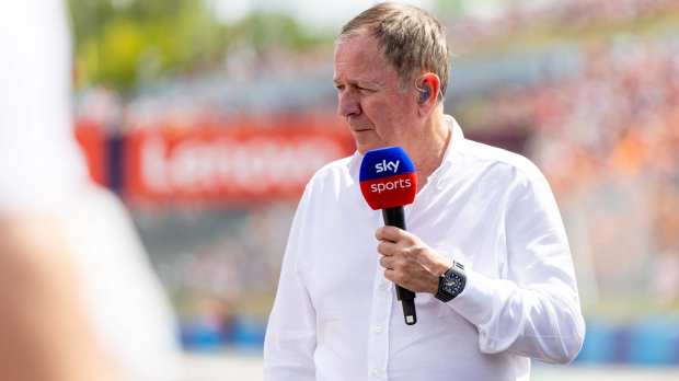 Martin Brundle speaks into a Sky Sports microphone