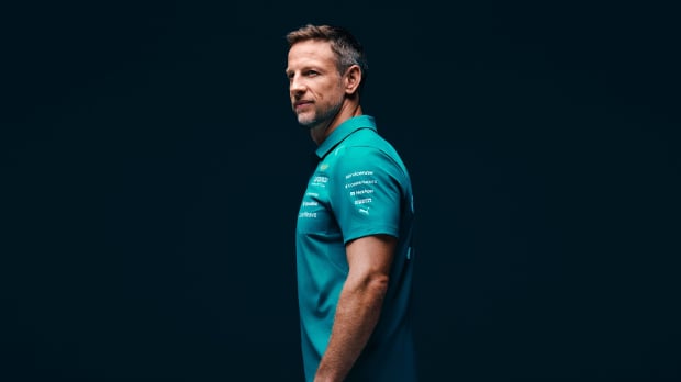 Jenson Button is pictured in Aston Martin teamwear after joining as an ambassador